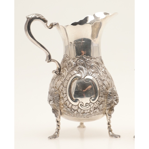86 - A VICTORIAN GEORGE II STYLE IRISH SILVER CREAM JUG AND SUGAR BOWL. The jug and sugar bowl both with ... 