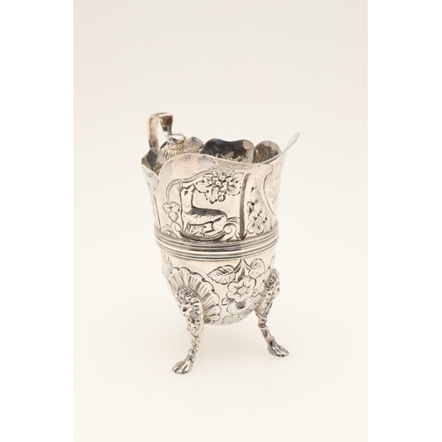 89 - A LATE VICTORIAN IRISH STYLE SILVER CREAM JUG. With later chased decoration of flora and fauna, scro... 