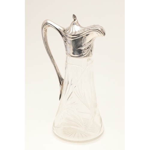 99 - A LATE 19TH CENTURY ARTS AND CRAFTS GERMAN SILVER MOUNTED GLASS CLARET JUG. An Arts and Crafts clare... 