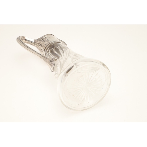 99 - A LATE 19TH CENTURY ARTS AND CRAFTS GERMAN SILVER MOUNTED GLASS CLARET JUG. An Arts and Crafts clare... 