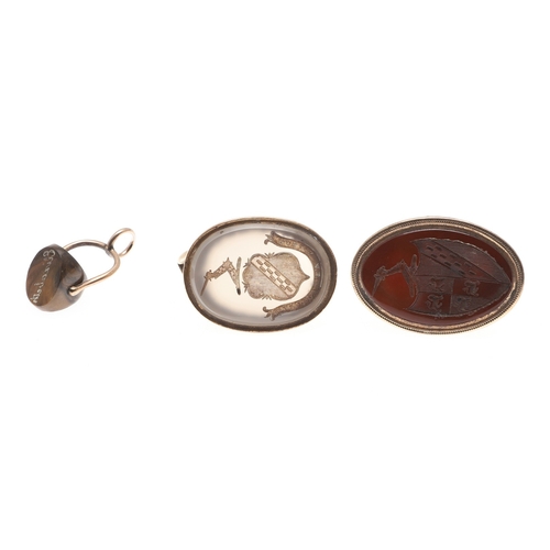 119 - TWO GEORGE 111 GOLD FOB SEALS. each with oval hardstone armorial intaglio and another small seal.