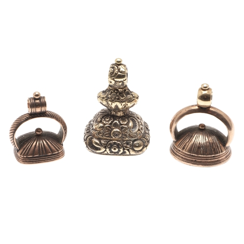 120 - THREE 19TH C. GOLD FOB SEALS. each with hardstone armorial intaglio and one with floral decoration.