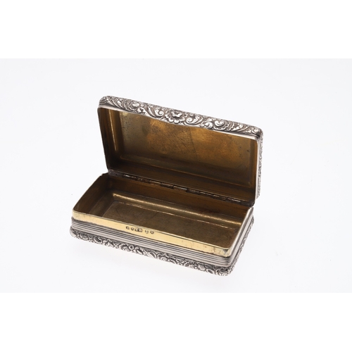 128 - A GEORGE III SILVER SNUFF BOX. Of oblong form, with reeded decoration and chased floral borders with... 