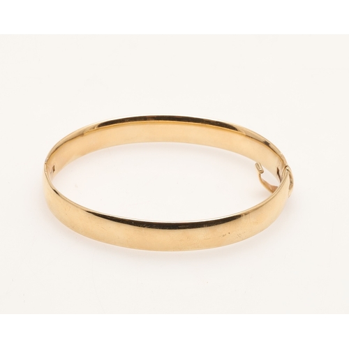 154 - A 9CT GOLD HALF HINGED BANGLE. of plain form, internal measurements 5.3cm x 6.5cm., 40.8 grams.
