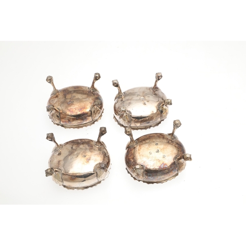 18 - A SET OF FOUR GEORGE III SILVER SALT CELLARS. Of oval form with gadrooned rim and gilded interior, t... 
