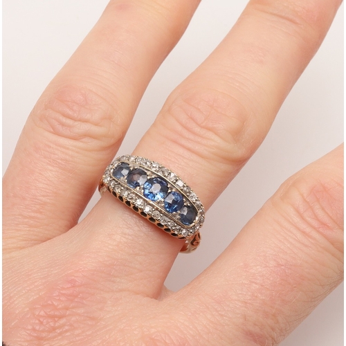 209 - A SAPPHIRE AND DIAMOND RING. the central row of graduated circular-cut sapphires is set within a sur... 