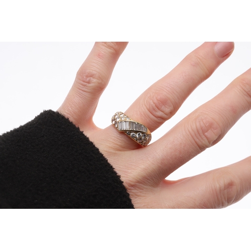 223 - A DIAMOND CROSS-OVER HALF HOOP RING. set to one side with graduated circular-cut diamonds, with a ce... 