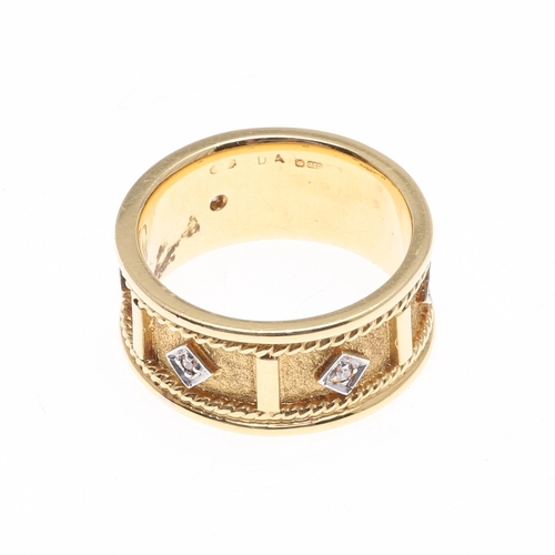 226 - A DIAMOND AND 18CT GOLD RING. the gold textured band with rope decoration and mounted with five circ... 