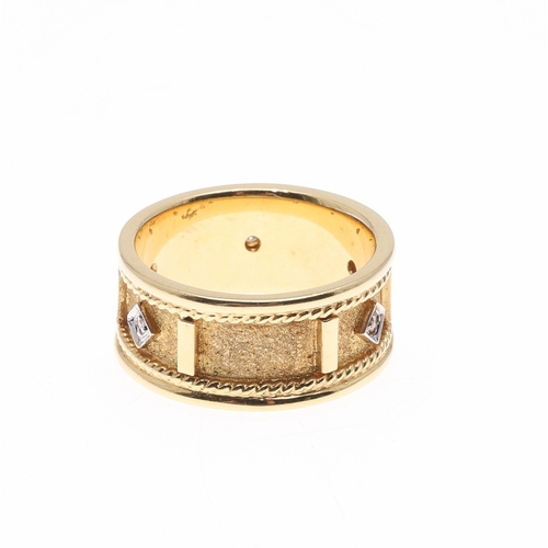 226 - A DIAMOND AND 18CT GOLD RING. the gold textured band with rope decoration and mounted with five circ... 