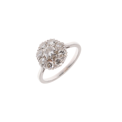 235 - A DIAMOND CLUSTER RING. the central circular-cut diamond is set within a surround of eight circular-... 