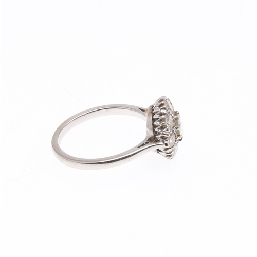 235 - A DIAMOND CLUSTER RING. the central circular-cut diamond is set within a surround of eight circular-... 