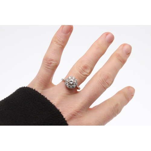 235 - A DIAMOND CLUSTER RING. the central circular-cut diamond is set within a surround of eight circular-... 