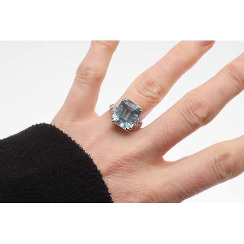 237 - AN AQUAMARINE AND DIAMOND RING. the step-cut aquamarine is set with three circular-cut diamonds to e... 