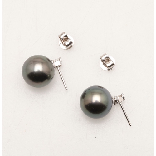 243 - A PAIR OF BLACK CULTURED PEARL AND DIAMOND STUD EARRINGS. each earring set with a cultured pearl mea... 