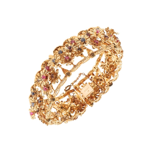 246 - A RUBY, SAPPHIRE, AMETHYST AND 18CT GOLD BRACELET BY KUTCHINSKY. the gold panel bracelet is mounted ... 