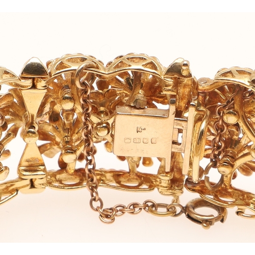 246 - A RUBY, SAPPHIRE, AMETHYST AND 18CT GOLD BRACELET BY KUTCHINSKY. the gold panel bracelet is mounted ... 