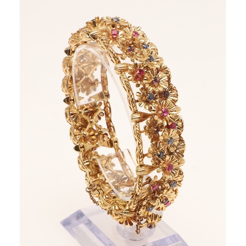246 - A RUBY, SAPPHIRE, AMETHYST AND 18CT GOLD BRACELET BY KUTCHINSKY. the gold panel bracelet is mounted ... 
