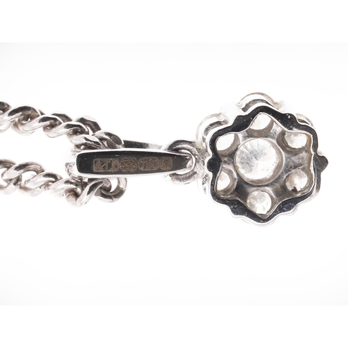 266 - A DIAMOND CLUSTER PENDANT. mounted with seven circular-cut diamonds, in 18ct white gold, on an 18ct ... 