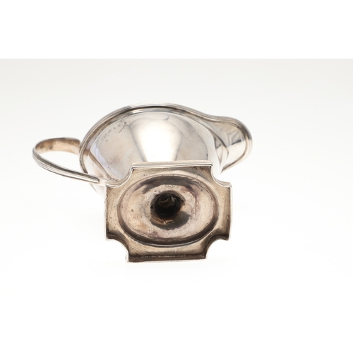 29 - A GEORGE III SILVER HELMET SHAPED CREAM JUG. The helmet shape bowl with handle, on a rectangular bas... 