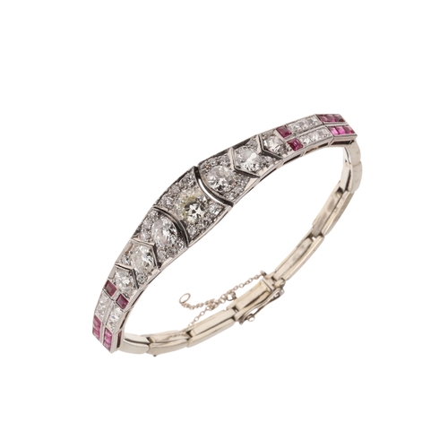 309 - AN ART DECO RUBY AND DIAMOND BRACELET. the bracelet is formed with eleven articulated sections, the ... 
