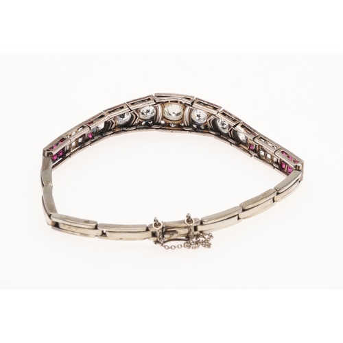 309 - AN ART DECO RUBY AND DIAMOND BRACELET. the bracelet is formed with eleven articulated sections, the ... 