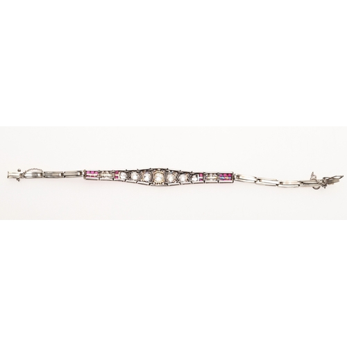 309 - AN ART DECO RUBY AND DIAMOND BRACELET. the bracelet is formed with eleven articulated sections, the ... 