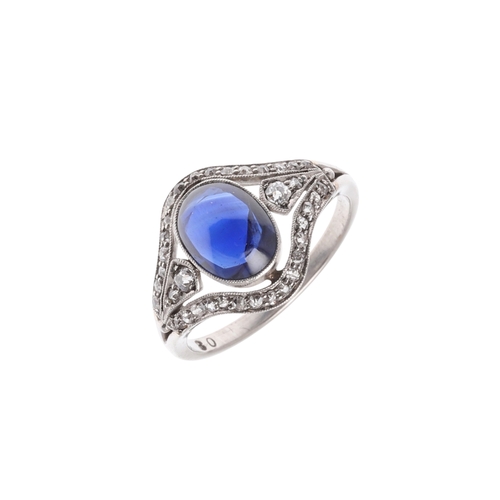 310 - AN EDWARDIAN SAPPHIRE AND DIAMOND RING. set with an oval-shaped cabochon sapphire within a surround ... 