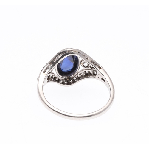 310 - AN EDWARDIAN SAPPHIRE AND DIAMOND RING. set with an oval-shaped cabochon sapphire within a surround ... 