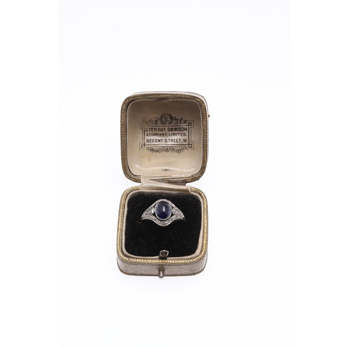 310 - AN EDWARDIAN SAPPHIRE AND DIAMOND RING. set with an oval-shaped cabochon sapphire within a surround ... 