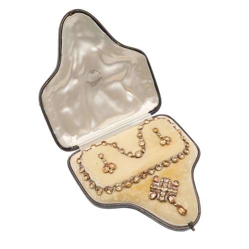 325 - AN EARLY VICTORIAN TOPAZ SUITE OF JEWELLERY. comprising a riviere necklace, mounted with circular to... 