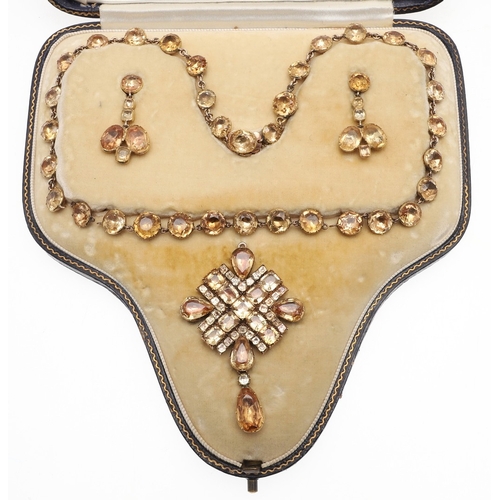 325 - AN EARLY VICTORIAN TOPAZ SUITE OF JEWELLERY. comprising a riviere necklace, mounted with circular to... 