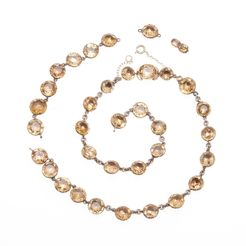 325 - AN EARLY VICTORIAN TOPAZ SUITE OF JEWELLERY. comprising a riviere necklace, mounted with circular to... 