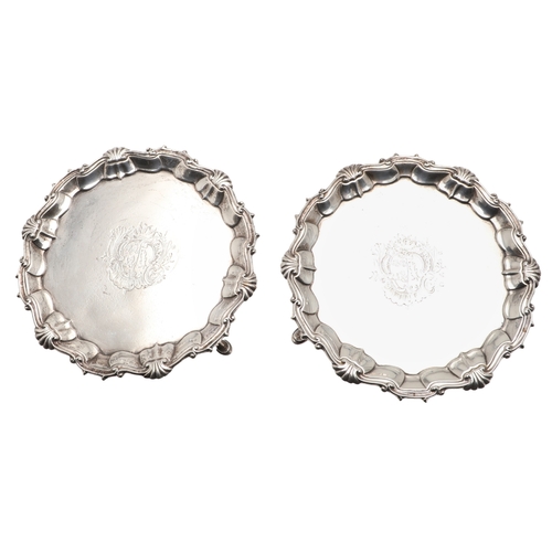 35 - A PAIR OF GEORGE II SILVER WAITERS. Of circular form, the cast border decorated with scrolls and she... 