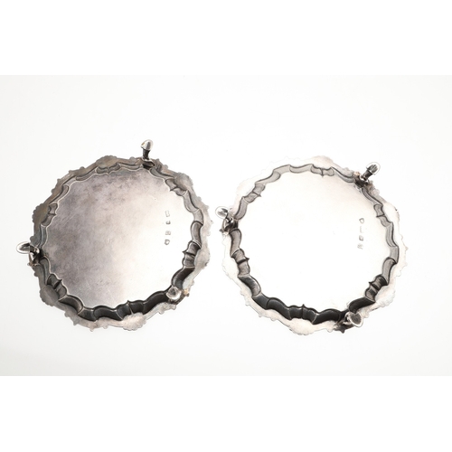 35 - A PAIR OF GEORGE II SILVER WAITERS. Of circular form, the cast border decorated with scrolls and she... 