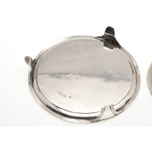 37 - A PAIR OF SMALL GEORGE III SILVER SALVERS. Of circular form with central engraved crest, raised on t... 