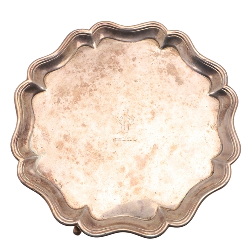 38 - A GEORGE III SILVER WAITER. Of shaped circular form, with interesting central engraved crest. Hallma... 