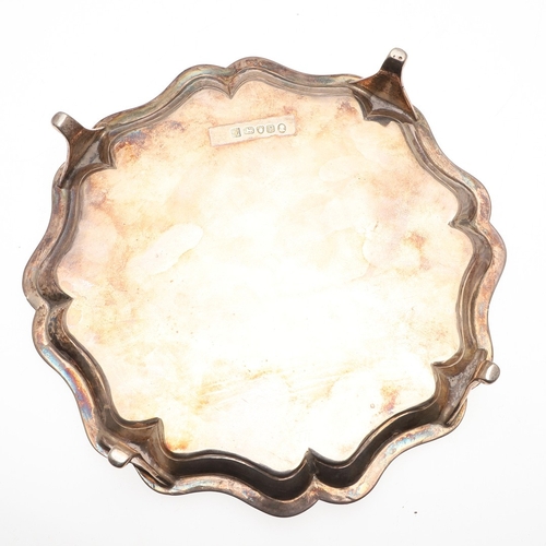 38 - A GEORGE III SILVER WAITER. Of shaped circular form, with interesting central engraved crest. Hallma... 