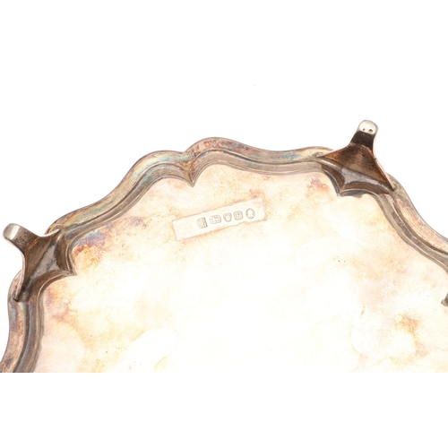 38 - A GEORGE III SILVER WAITER. Of shaped circular form, with interesting central engraved crest. Hallma... 