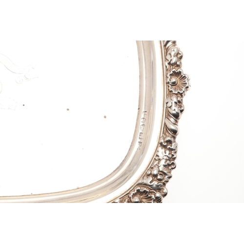 40 - A PAIR OF GEORGE III RECTANGULAR SILVER SALVERS. With cast foliate motif borders and engraved centra... 