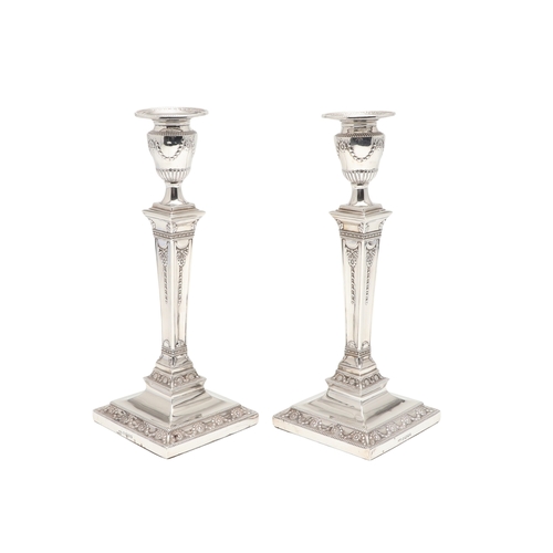 60 - A PAIR OF VICTORIAN SILVER CANDLESTICKS. Each candlestick with a beaded circular sconce, urn shaped ... 