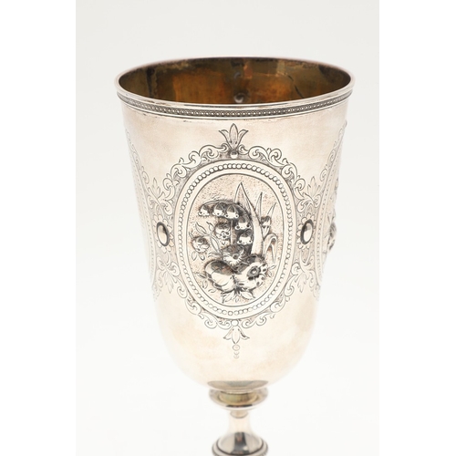 62 - A VICTORIAN SILVER GOBLET. With engraved and repousse decoration of floral cartouches and other desi... 