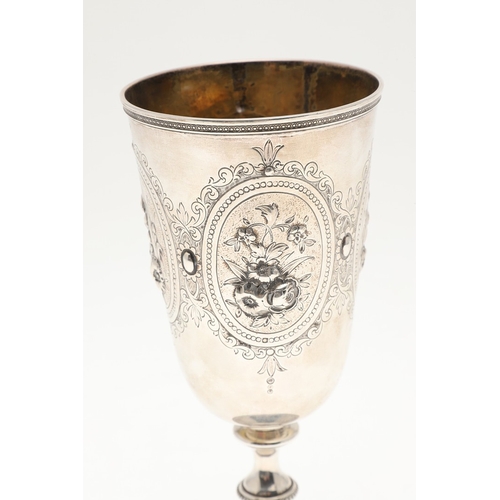 62 - A VICTORIAN SILVER GOBLET. With engraved and repousse decoration of floral cartouches and other desi... 