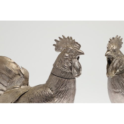 69 - A PAIR OF EARLY 20TH CENTURY IMPORTED SILVER STUDIES OF COCKERELS. Of the same pose, with foreign ma... 