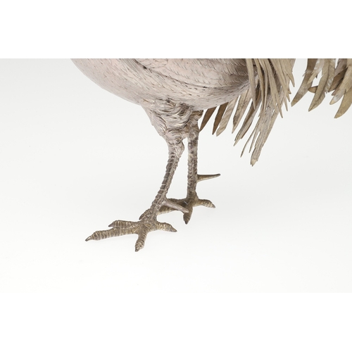 69 - A PAIR OF EARLY 20TH CENTURY IMPORTED SILVER STUDIES OF COCKERELS. Of the same pose, with foreign ma... 