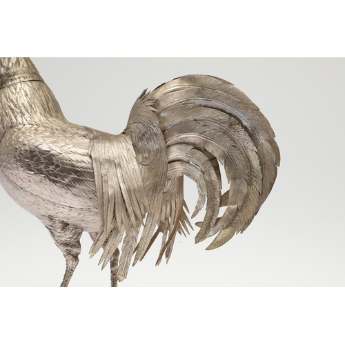 69 - A PAIR OF EARLY 20TH CENTURY IMPORTED SILVER STUDIES OF COCKERELS. Of the same pose, with foreign ma... 