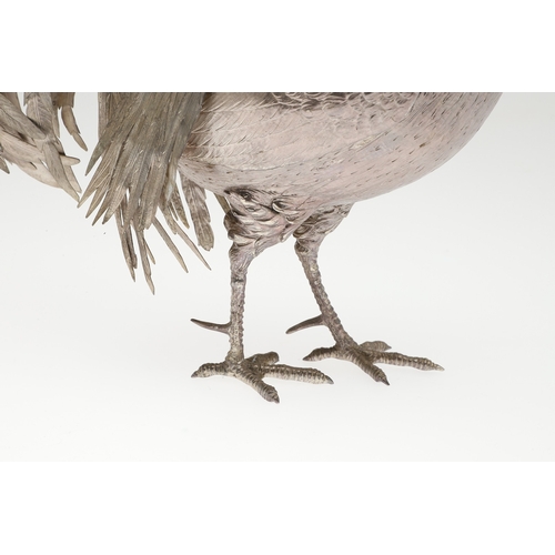 69 - A PAIR OF EARLY 20TH CENTURY IMPORTED SILVER STUDIES OF COCKERELS. Of the same pose, with foreign ma... 