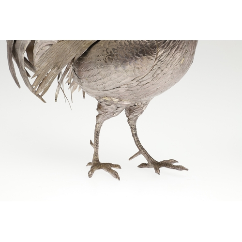 69 - A PAIR OF EARLY 20TH CENTURY IMPORTED SILVER STUDIES OF COCKERELS. Of the same pose, with foreign ma... 