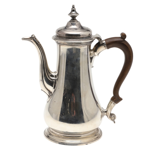 74 - A LATE GEORGE II SILVER COFFEE POT. Of plain baluster form, with scroll handle and round foot, the l... 
