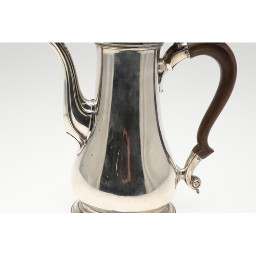 74 - A LATE GEORGE II SILVER COFFEE POT. Of plain baluster form, with scroll handle and round foot, the l... 