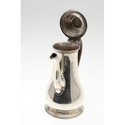 74 - A LATE GEORGE II SILVER COFFEE POT. Of plain baluster form, with scroll handle and round foot, the l... 